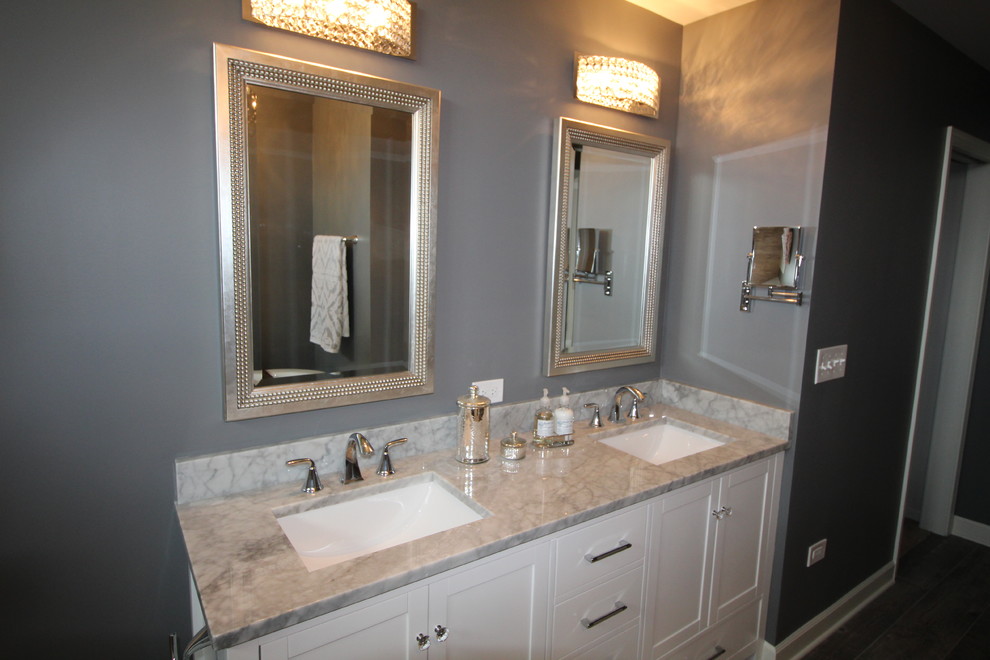 This is an example of a medium sized classic ensuite bathroom in Nashville with recessed-panel cabinets, white cabinets, a freestanding bath, a corner shower, a one-piece toilet, grey walls and a submerged sink.