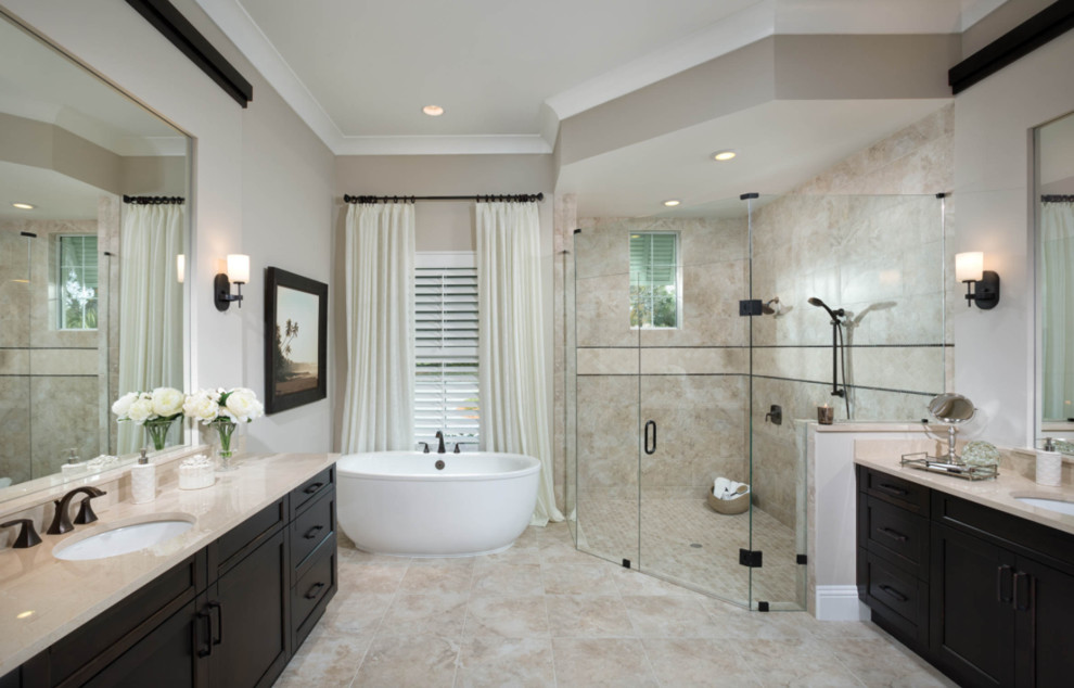 Inspiration for a mid-sized eclectic master beige tile and travertine tile travertine floor and beige floor bathroom remodel in San Diego with recessed-panel cabinets, dark wood cabinets, beige walls, an undermount sink, marble countertops and a hinged shower door