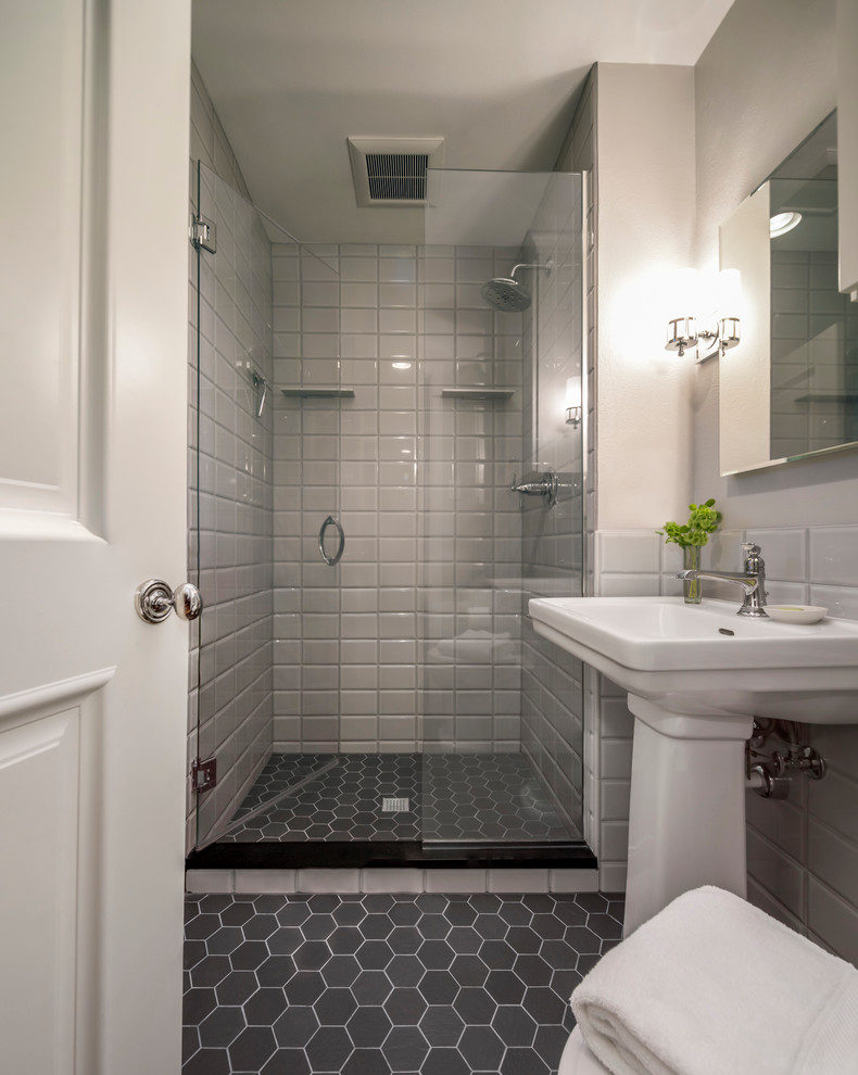 Photo of a small traditional grey and white shower room bathroom in Denver with grey tiles, porcelain flooring, a pedestal sink, black floors, a hinged door and a single sink.