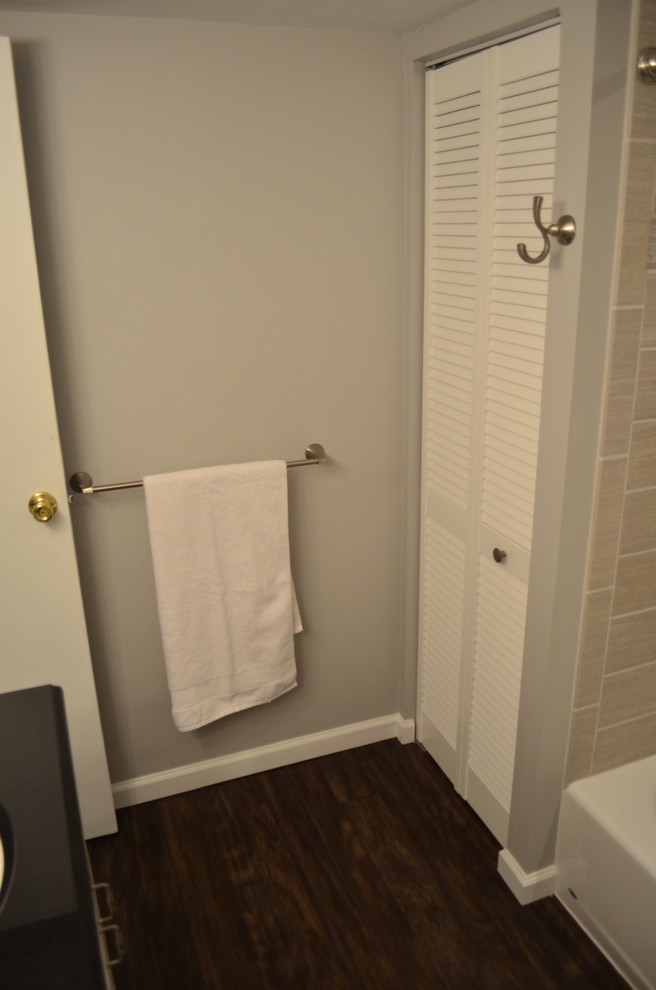 Exemple d'une salle de bain moderne de taille moyenne pour enfant avec un lavabo encastré, un placard avec porte à panneau surélevé, des portes de placard blanches, un plan de toilette en granite, une baignoire en alcôve, un combiné douche/baignoire, WC séparés, un carrelage beige, des carreaux de porcelaine, un mur gris et un sol en linoléum.