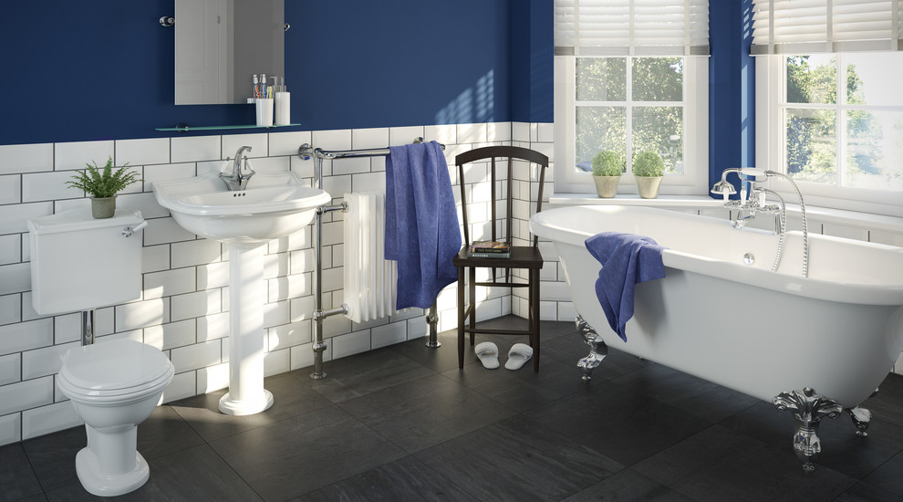 Design ideas for a large classic ensuite bathroom in Hampshire with a wall-mounted sink, a claw-foot bath, a shower/bath combination, a one-piece toilet, white tiles, blue walls and dark hardwood flooring.