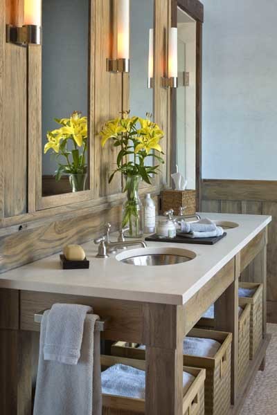 This is an example of a medium sized rustic ensuite bathroom in New York with open cabinets, medium wood cabinets, white walls, pebble tile flooring, a submerged sink, limestone worktops and beige floors.