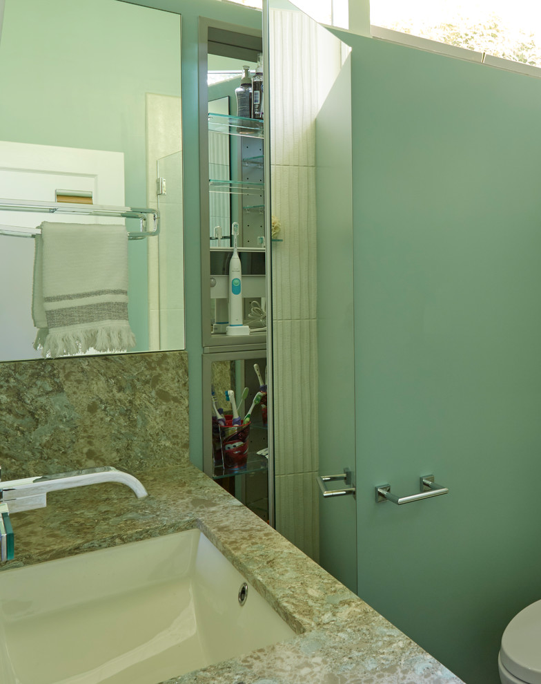 На фото: маленькая главная ванная комната в стиле ретро с плоскими фасадами, светлыми деревянными фасадами, открытым душем, унитазом-моноблоком, белой плиткой, керамогранитной плиткой, зелеными стенами, полом из керамогранита, врезной раковиной, столешницей из искусственного кварца, коричневым полом, душем с распашными дверями и бирюзовой столешницей для на участке и в саду
