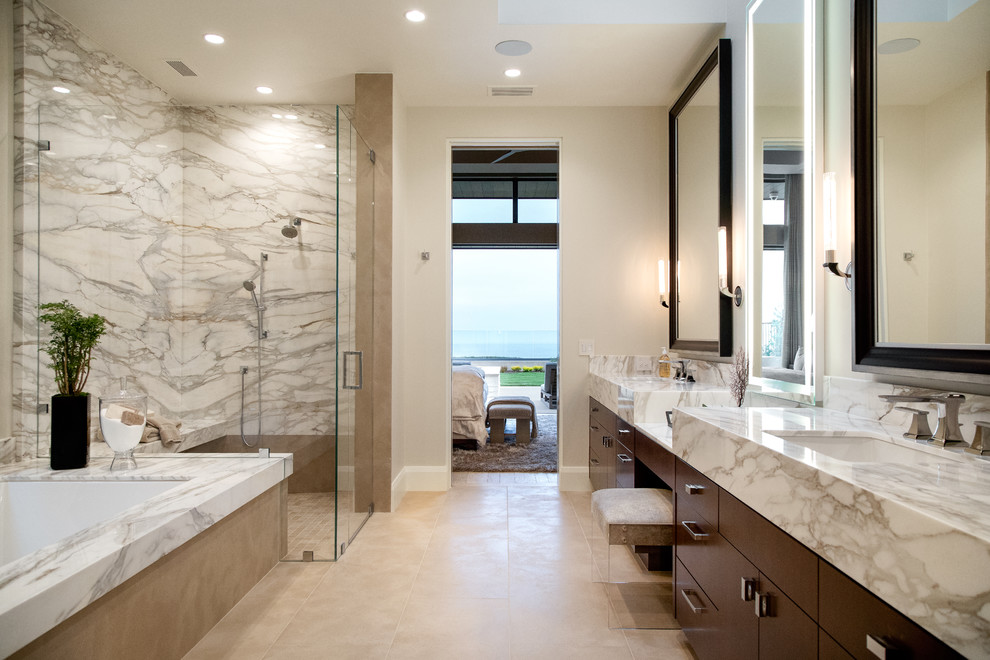 Contemporary ensuite bathroom in Orange County with flat-panel cabinets, dark wood cabinets, a submerged bath, a built-in shower, multi-coloured tiles, marble tiles, beige walls, a submerged sink, marble worktops, beige floors, a hinged door and multi-coloured worktops.