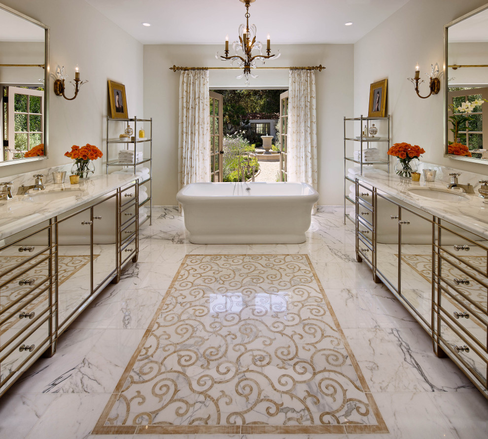 Example of a tuscan white floor freestanding bathtub design in Santa Barbara with flat-panel cabinets, beige walls, an undermount sink and white countertops