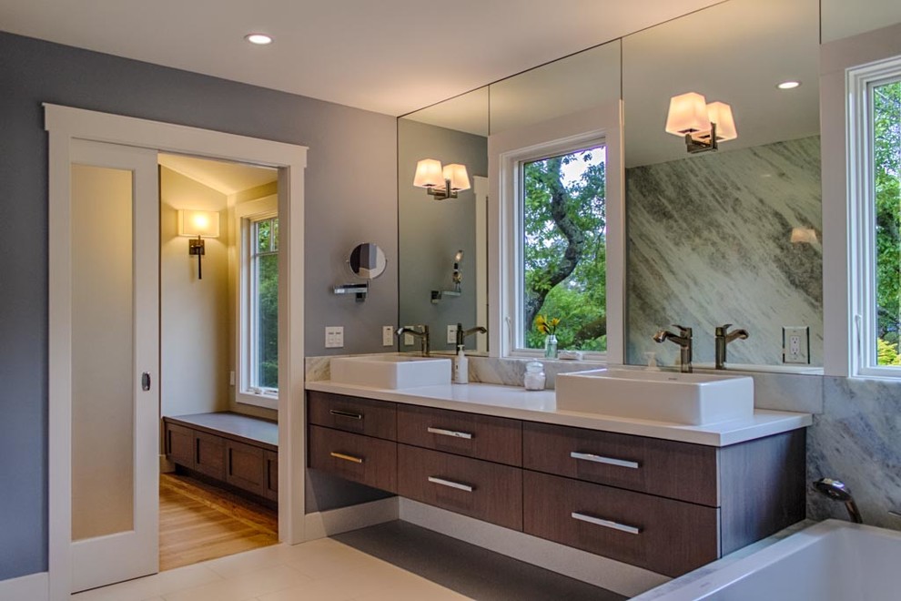 Photo of a contemporary bathroom in San Francisco with a vessel sink, flat-panel cabinets, dark wood cabinets, a built-in bath, an alcove shower, grey walls, light hardwood flooring, beige floors and an open shower.