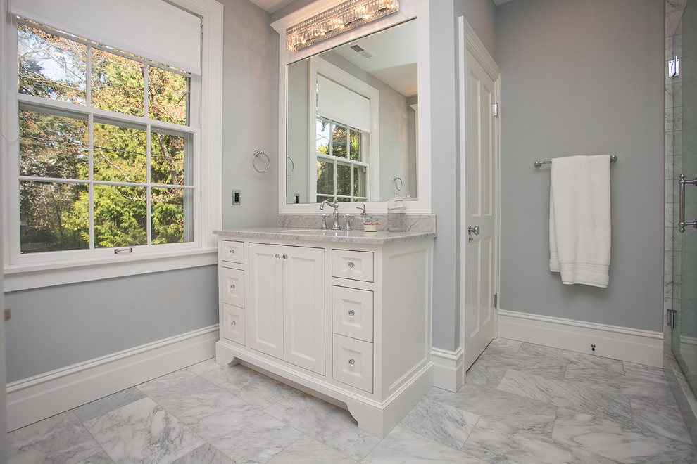 This is an example of a medium sized classic grey and white ensuite bathroom in Portland with shaker cabinets, white cabinets, an alcove shower, all types of toilet, white walls, laminate floors, a submerged sink, grey floors, a hinged door, grey worktops, a single sink and a built in vanity unit.