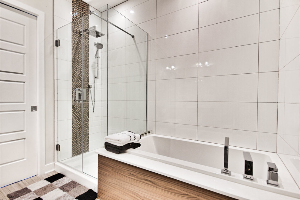 Medium sized contemporary ensuite bathroom in Montreal with a built-in sink, flat-panel cabinets, medium wood cabinets, laminate worktops, a built-in bath, a corner shower, a one-piece toilet, white tiles, porcelain tiles, white walls and porcelain flooring.