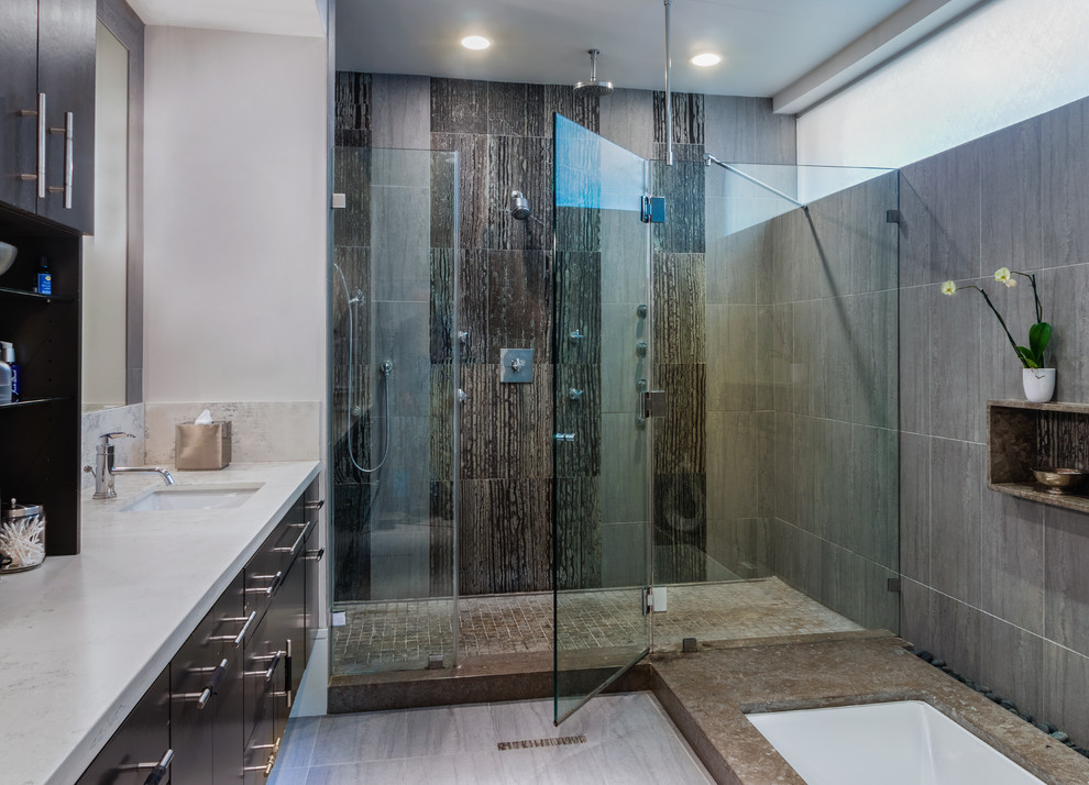 Inspiration for a large contemporary ensuite bathroom in Houston with flat-panel cabinets, dark wood cabinets, a built-in bath, an alcove shower, brown tiles, a submerged sink, beige floors, a hinged door and white worktops.