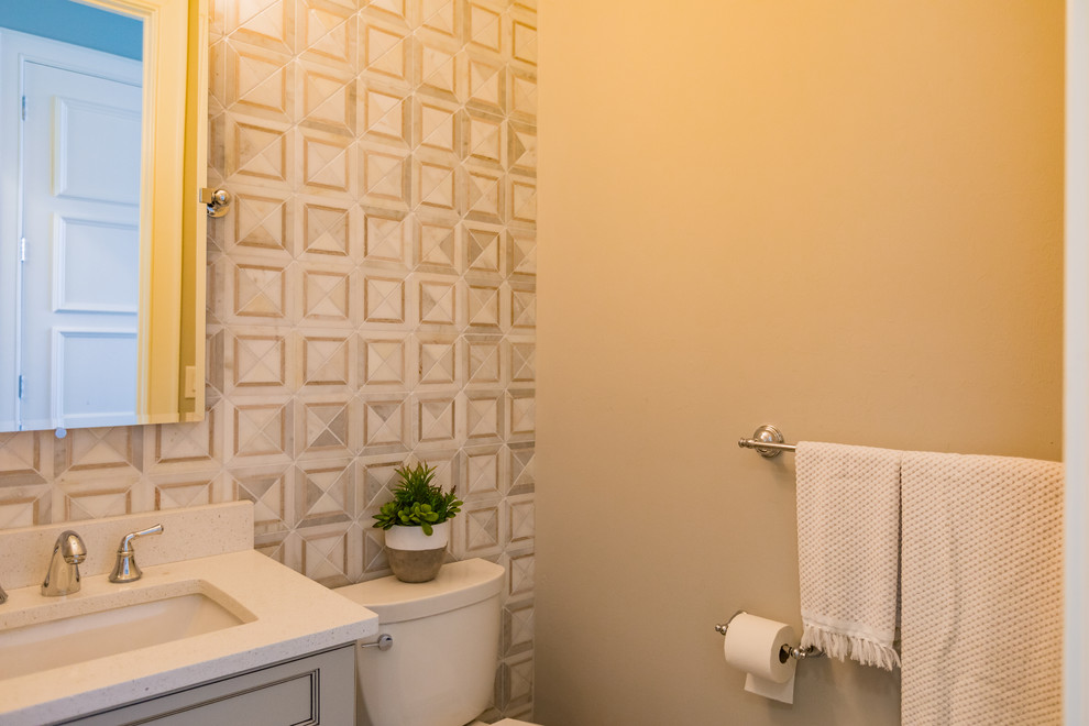 Small transitional 3/4 white tile and marble tile alcove shower photo in Miami with shaker cabinets, gray cabinets, a two-piece toilet, white walls, an undermount sink, limestone countertops and a hinged shower door