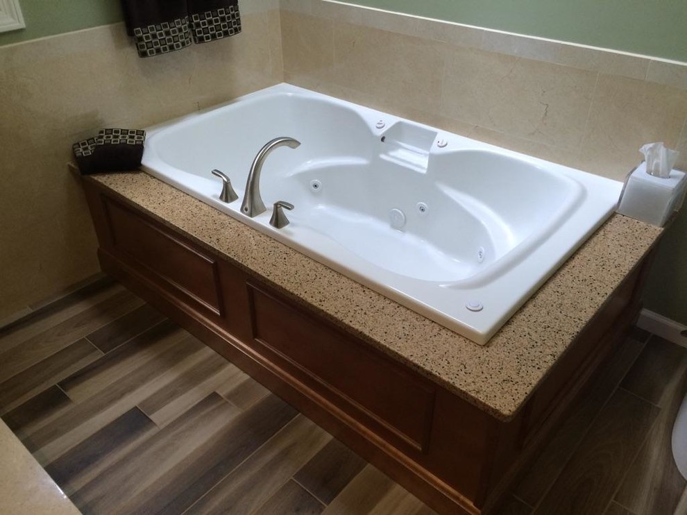 Mid-sized trendy master yellow tile and porcelain tile porcelain tile bathroom photo in New York with an undermount sink, recessed-panel cabinets, brown cabinets, quartz countertops, a one-piece toilet and brown walls
