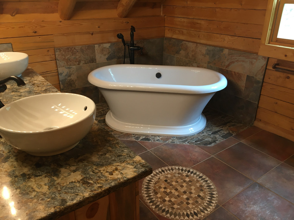 Medium sized rustic ensuite bathroom in Denver with a freestanding bath, stone tiles, mosaic tile flooring, a vessel sink, quartz worktops, multi-coloured worktops, double sinks, a built in vanity unit and wood walls.