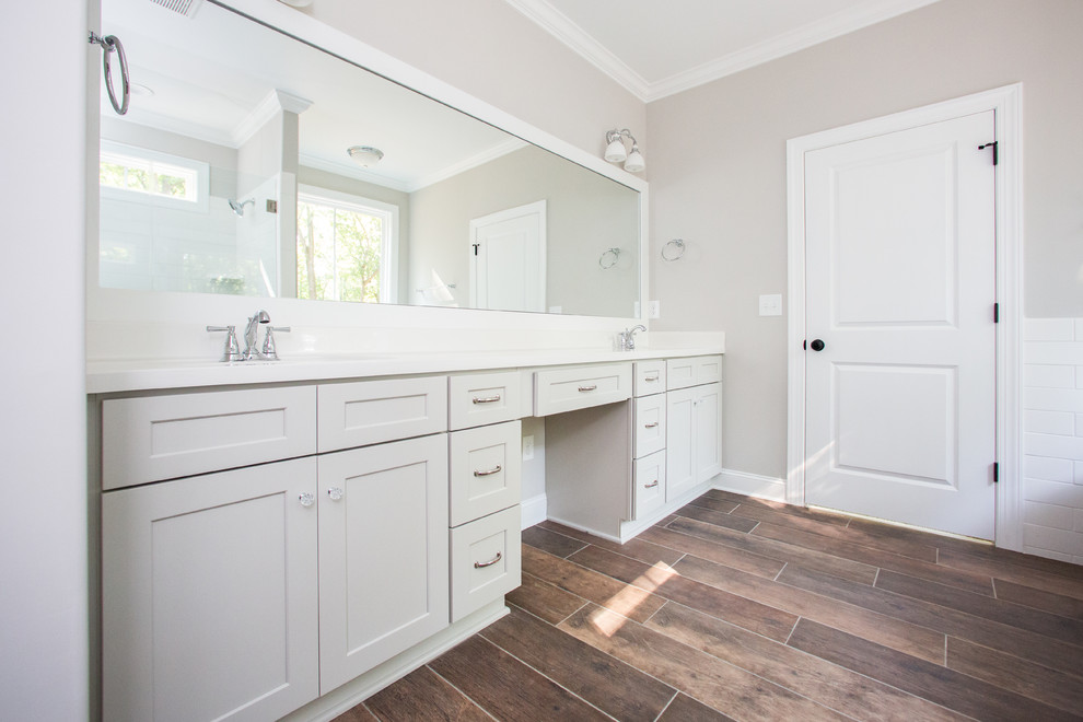 Large country master dark wood floor and brown floor bathroom photo in Other with shaker cabinets, white cabinets, beige walls, an integrated sink and a hinged shower door