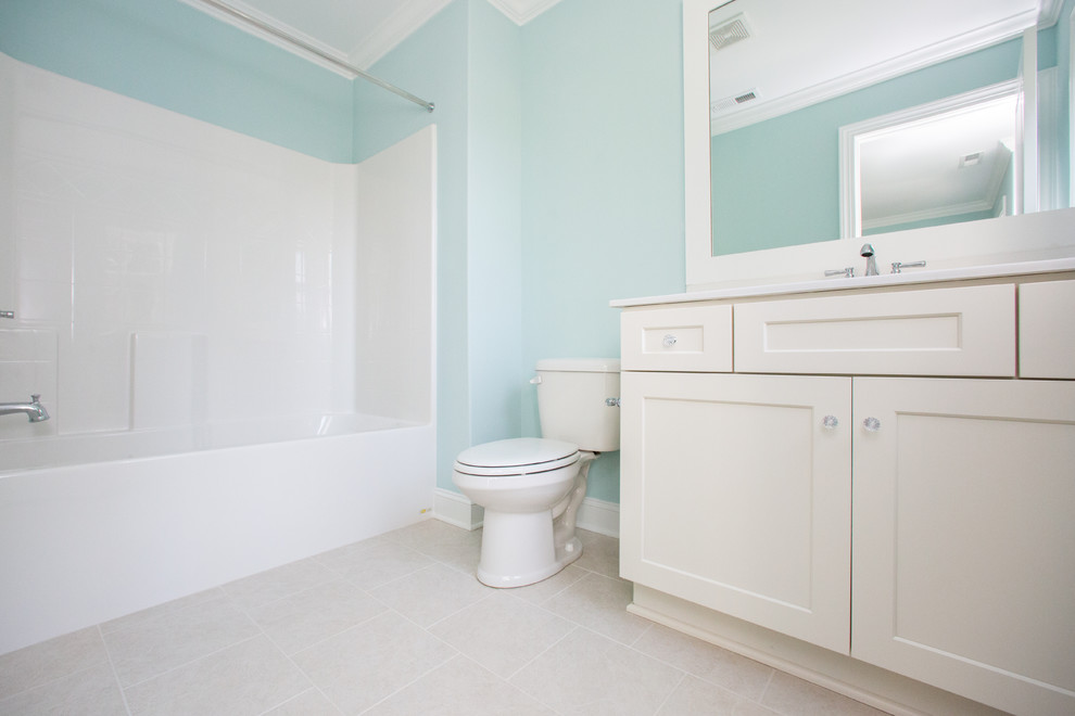 Design ideas for a medium sized country shower room bathroom in Other with shaker cabinets, white cabinets, an alcove bath, a shower/bath combination, blue walls, an integrated sink, beige floors and a shower curtain.