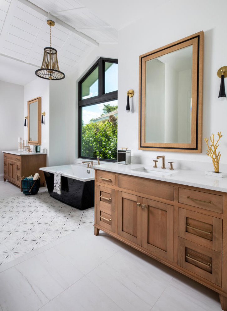 Example of a large beach style master white tile and porcelain tile porcelain tile and white floor bathroom design in Miami with furniture-like cabinets, medium tone wood cabinets, a two-piece toilet, white walls, a drop-in sink, quartz countertops, a hinged shower door and white countertops