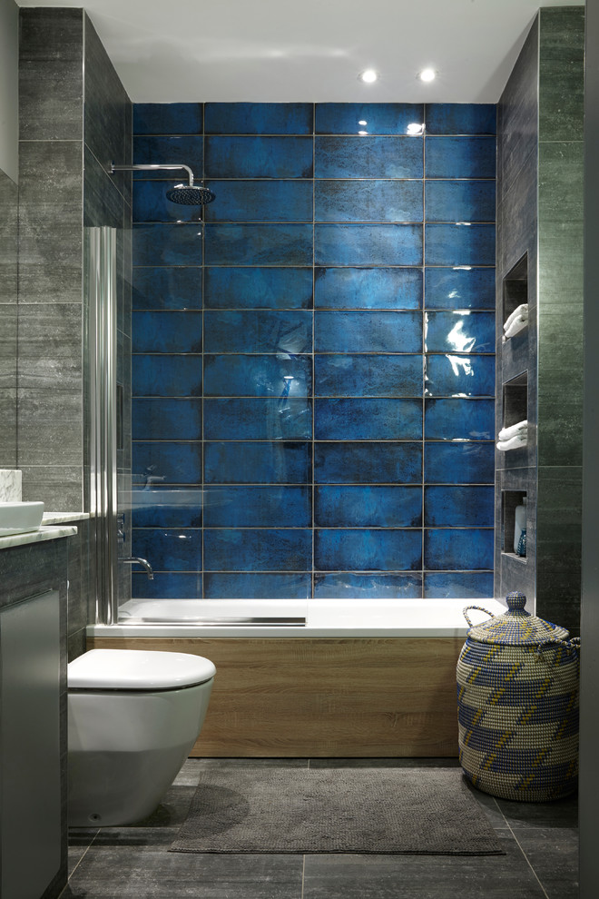 Inspiration for a contemporary bathroom in Edinburgh with an alcove bath, a shower/bath combination, blue tiles, grey tiles, grey walls and an open shower.
