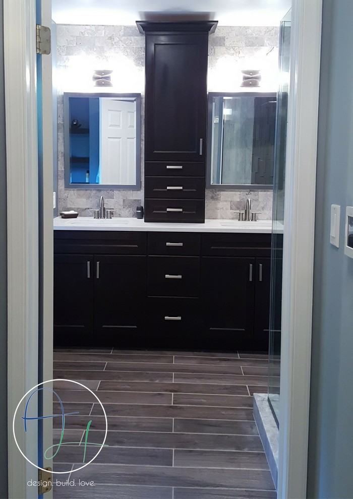 Inspiration for a mid-sized contemporary master gray tile and stone tile ceramic tile bathroom remodel in Newark with recessed-panel cabinets, dark wood cabinets, a two-piece toilet, blue walls, an undermount sink and quartzite countertops