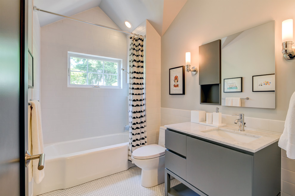 This is an example of a medium sized traditional family bathroom in Seattle with flat-panel cabinets, grey cabinets, an alcove bath, a shower/bath combination, a two-piece toilet, white tiles, ceramic tiles, mosaic tile flooring, a submerged sink, solid surface worktops, white floors, white walls and a shower curtain.