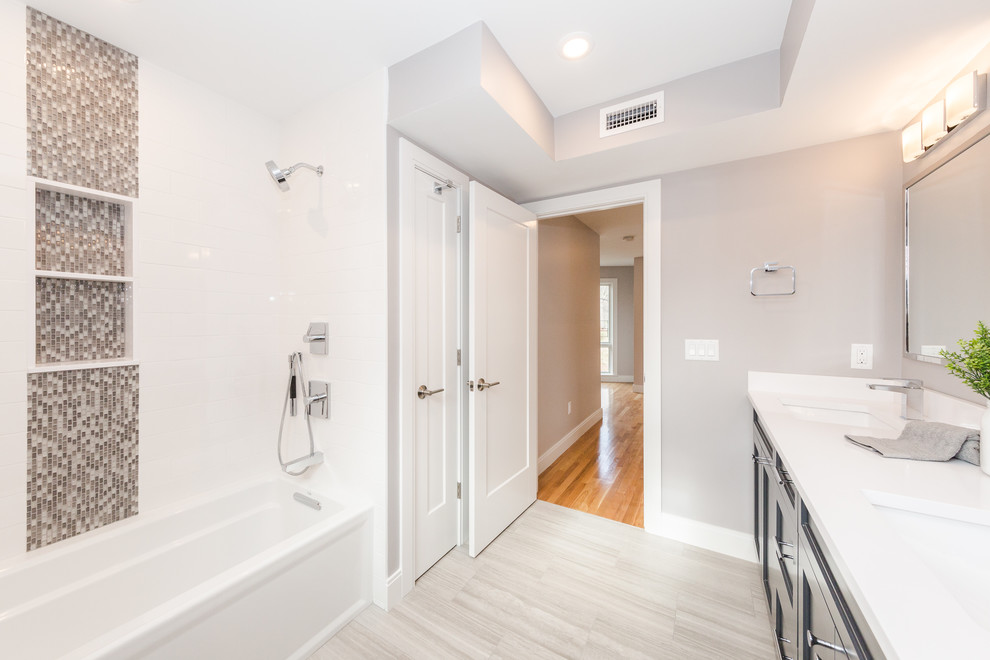 Photo of a medium sized contemporary shower room bathroom in Boston with shaker cabinets, grey cabinets, an alcove bath, an alcove shower, a one-piece toilet, white tiles, cement tiles, grey walls, porcelain flooring, a built-in sink, quartz worktops, grey floors, a shower curtain and white worktops.