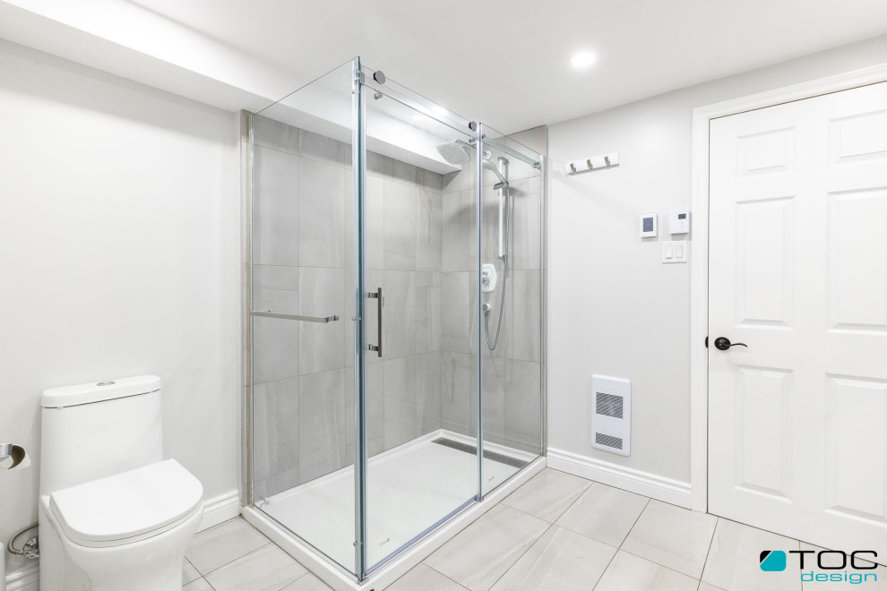 Photo of a large mediterranean shower room bathroom in Other with flat-panel cabinets, dark wood cabinets, a built-in shower, a one-piece toilet, grey tiles, ceramic tiles, grey walls, porcelain flooring, an integrated sink, solid surface worktops, grey floors, a shower curtain, white worktops, double sinks and a floating vanity unit.