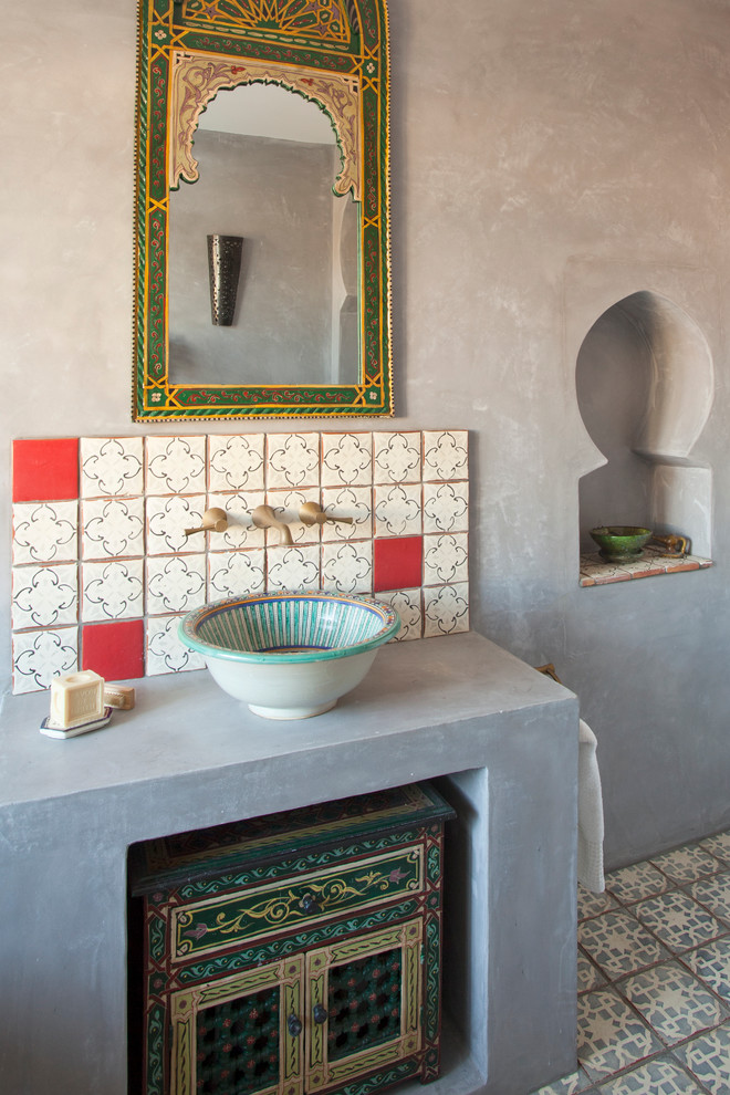 Drop-in bathtub - mid-sized mediterranean kids' multicolored tile and terra-cotta tile terra-cotta tile drop-in bathtub idea in Sussex with furniture-like cabinets, dark wood cabinets, a one-piece toilet, gray walls, a vessel sink and solid surface countertops