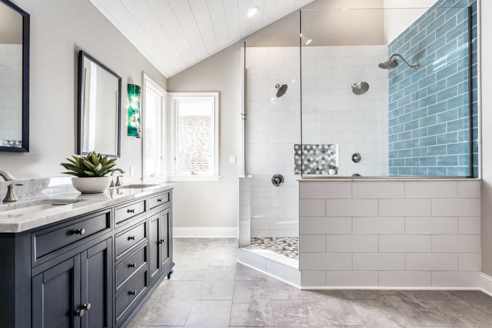Photo of a large traditional ensuite bathroom in Indianapolis with shaker cabinets, blue cabinets, a corner shower, white tiles, porcelain tiles, grey walls, vinyl flooring, a submerged sink, engineered stone worktops, grey floors, an open shower, white worktops, a wall niche, double sinks, a freestanding vanity unit, a timber clad ceiling and a vaulted ceiling.