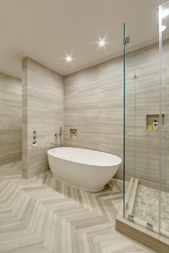 Large contemporary ensuite bathroom in New York with a submerged sink, flat-panel cabinets, light wood cabinets, limestone worktops, a freestanding bath, a corner shower, a one-piece toilet, brown tiles, stone tiles, brown walls and limestone flooring.