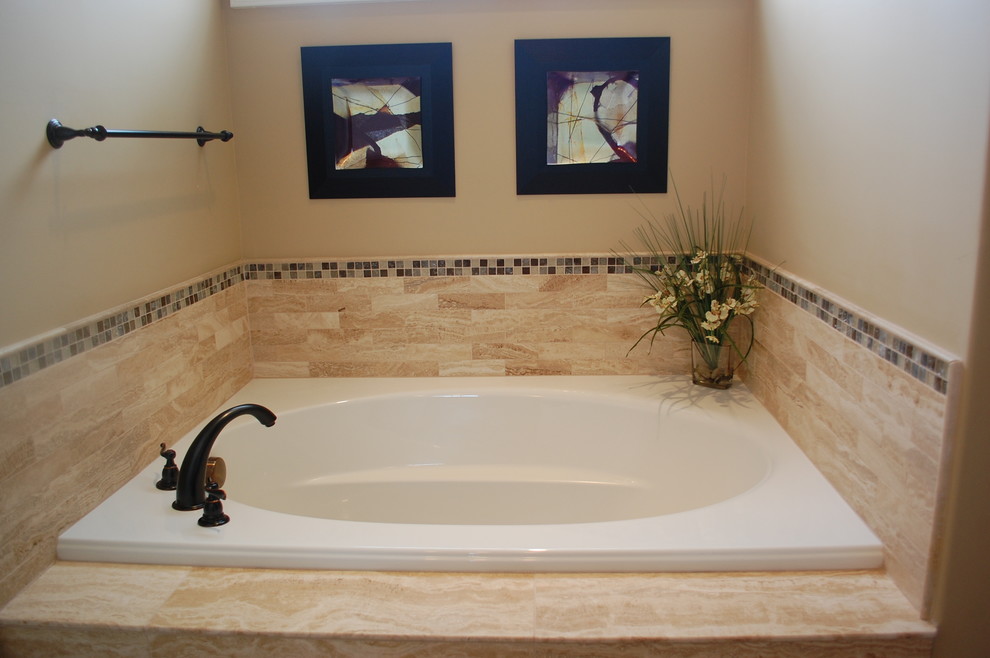 Bathroom - mid-sized traditional beige tile and porcelain tile porcelain tile bathroom idea in Indianapolis with a drop-in sink, raised-panel cabinets, medium tone wood cabinets, granite countertops, a one-piece toilet and beige walls