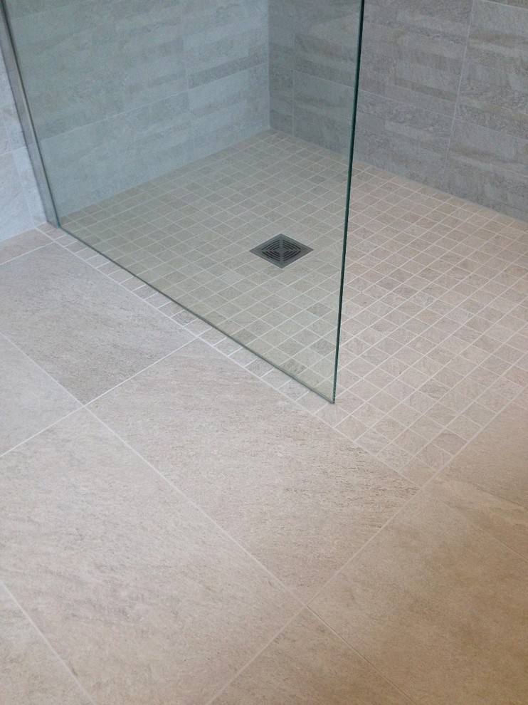 Example of a trendy kids' gray tile and porcelain tile porcelain tile doorless shower design in Berkshire with a one-piece toilet and gray walls