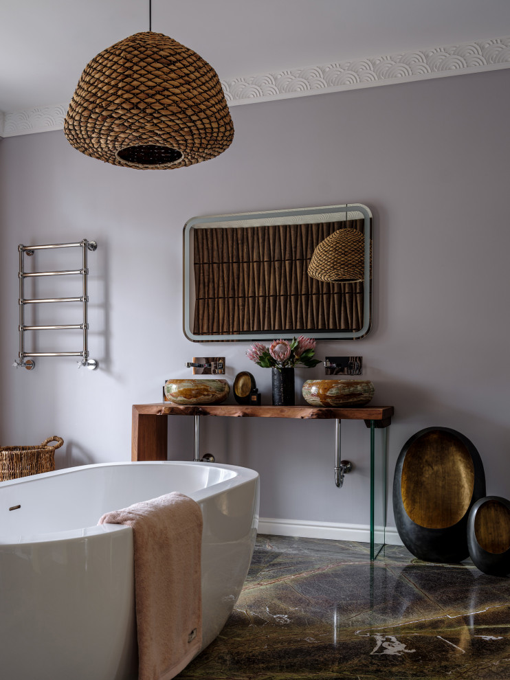 Inspiration for a large eclectic master marble floor, green floor and double-sink freestanding bathtub remodel in Moscow with a wall-mount toilet, purple walls, an undermount sink, wood countertops, brown countertops and a freestanding vanity