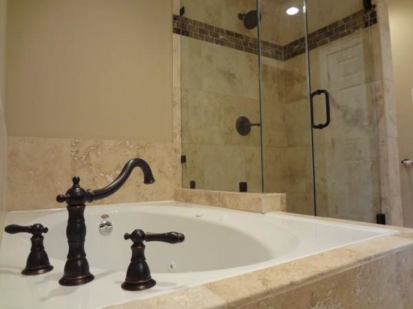 Inspiration for a mid-sized craftsman 3/4 stone tile travertine floor corner shower remodel in Houston with an undermount sink, flat-panel cabinets, a hot tub, a one-piece toilet and beige walls