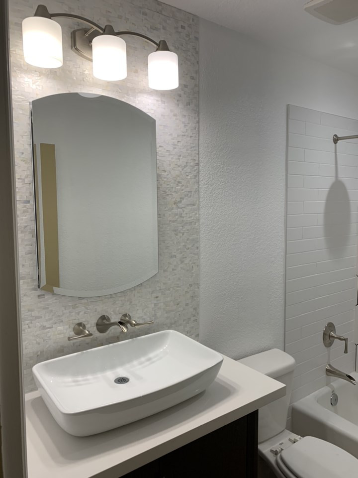Medium sized modern bathroom in Phoenix with a single sink, an alcove bath, a shower/bath combination, white tiles, ceramic tiles, wood-effect flooring and a shower curtain.