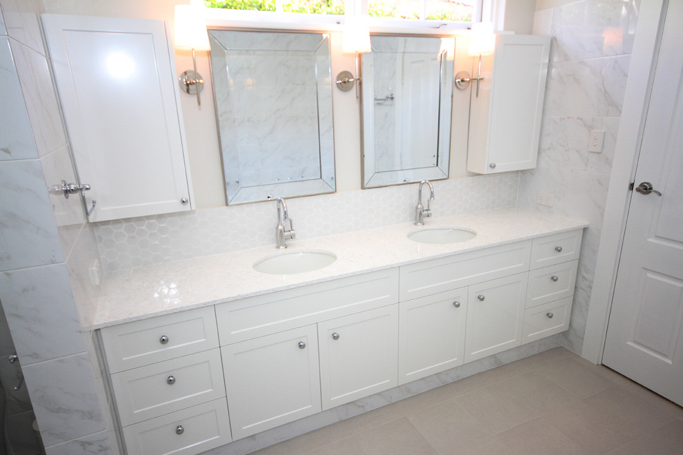 Design ideas for a traditional ensuite bathroom in Perth with shaker cabinets, white cabinets, a built-in bath, a one-piece toilet, white tiles, a submerged sink, engineered stone worktops and a hinged door.