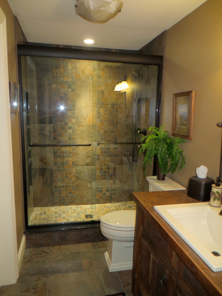 Medium sized rustic bathroom in Boston with medium wood cabinets, an alcove shower, a two-piece toilet, brown tiles, porcelain tiles, beige walls, porcelain flooring, a built-in sink and wooden worktops.