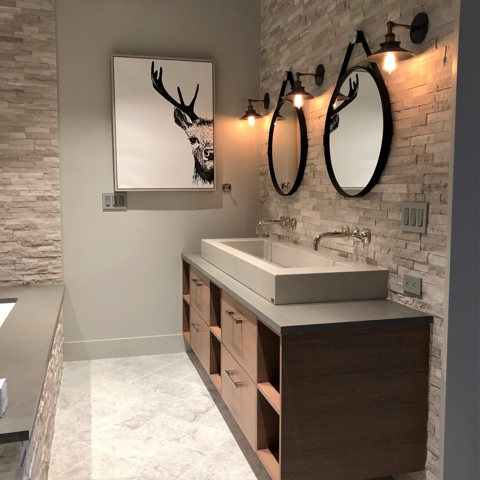 Inspiration for a mid-sized contemporary master gray tile and stone tile marble floor and gray floor bathroom remodel in Denver with flat-panel cabinets, medium tone wood cabinets, a two-piece toilet, gray walls, a vessel sink, quartzite countertops and gray countertops