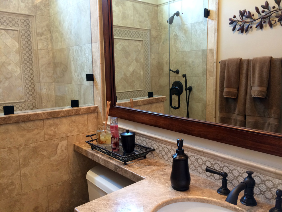 Small traditional shower room bathroom in Los Angeles with shaker cabinets, medium wood cabinets, a walk-in shower, a one-piece toilet, beige tiles, stone tiles, beige walls, ceramic flooring, a built-in sink and granite worktops.