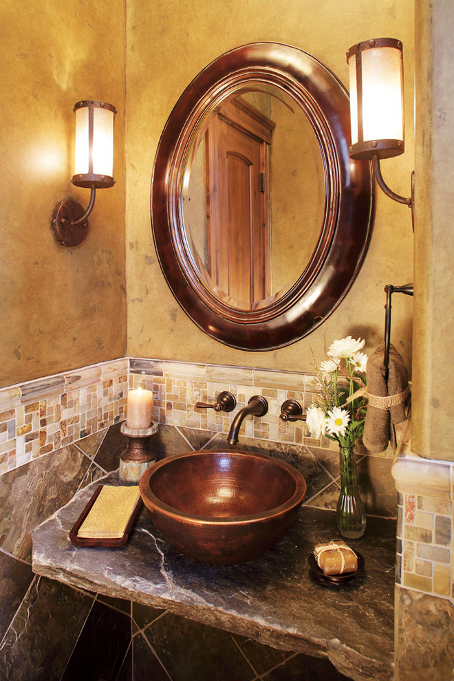 Bathroom - mid-sized cottage 3/4 multicolored tile and stone tile medium tone wood floor bathroom idea in Los Angeles with a vessel sink, soapstone countertops, a two-piece toilet and brown walls