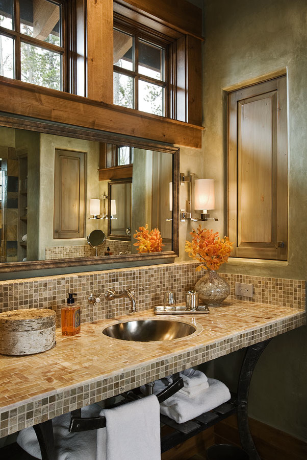 Cette image montre une grande salle de bain chalet avec un carrelage beige, un lavabo posé et un plan de toilette en carrelage.