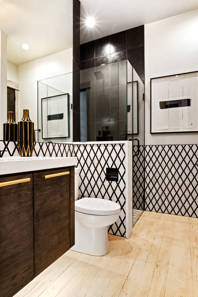 Example of a minimalist master white tile and marble tile marble floor and white floor bathroom design in Kansas City with flat-panel cabinets, dark wood cabinets, a one-piece toilet, white walls, an undermount sink, quartz countertops, a hinged shower door and white countertops