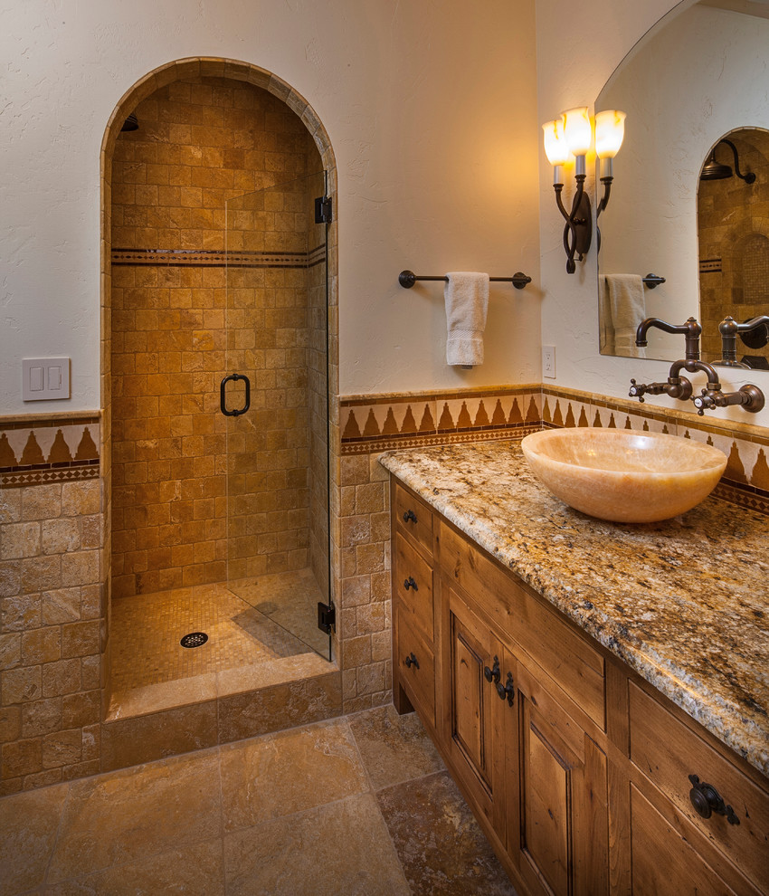 Example of a tuscan master beige tile and ceramic tile alcove shower design in Other with raised-panel cabinets, medium tone wood cabinets, white walls, a vessel sink and granite countertops