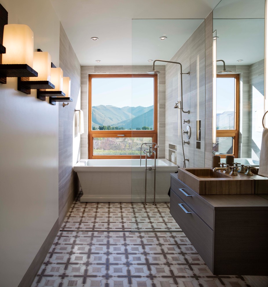 This is an example of a contemporary ensuite bathroom in San Francisco with a vessel sink, flat-panel cabinets, a freestanding bath, a walk-in shower, an open shower and brown worktops.