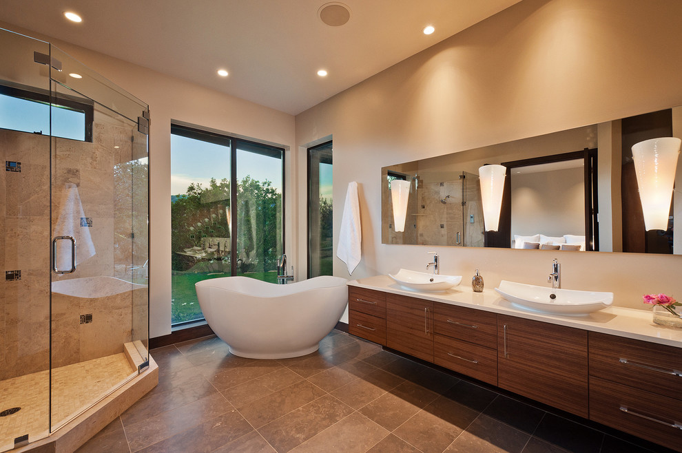 Inspiration for a large 3/4 beige tile and ceramic tile ceramic tile bathroom remodel in Salt Lake City with a vessel sink, flat-panel cabinets, dark wood cabinets, quartzite countertops, a wall-mount toilet and white walls