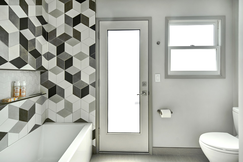 Mid-sized transitional kids' black and white tile and ceramic tile ceramic tile and gray floor bathroom photo in San Francisco with raised-panel cabinets, light wood cabinets, a one-piece toilet, gray walls, an integrated sink, solid surface countertops and white countertops