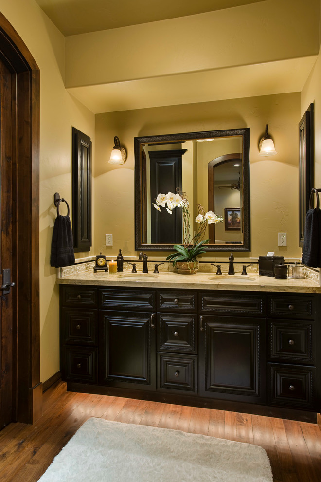 Photo of a rustic bathroom in Other with black cabinets and yellow walls.