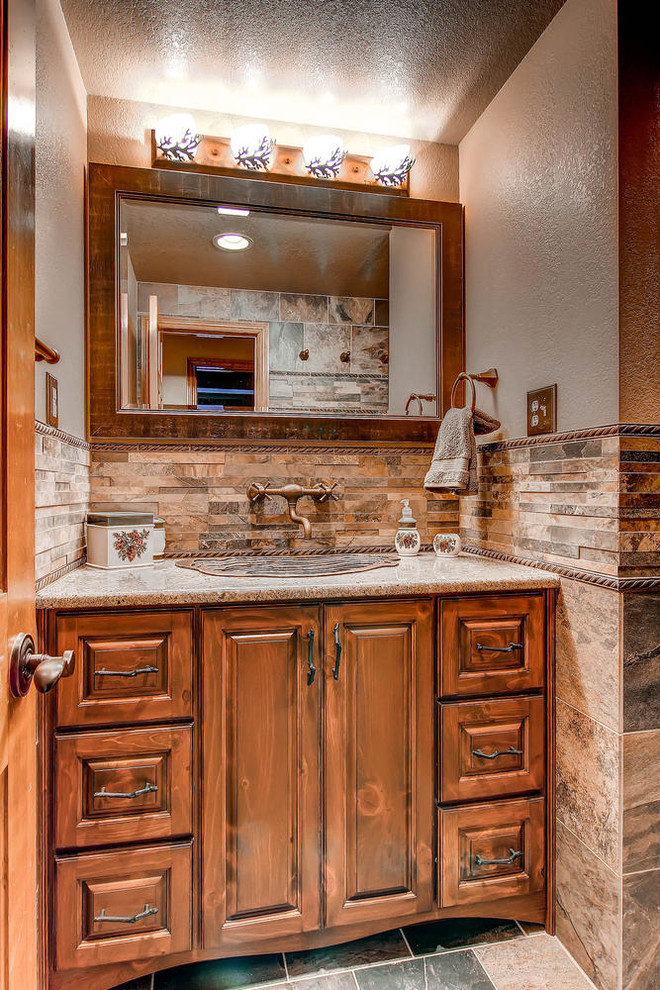Example of a large mountain style master beige tile and ceramic tile ceramic tile double shower design in Denver with a drop-in sink, raised-panel cabinets, medium tone wood cabinets, granite countertops, a two-piece toilet and multicolored walls