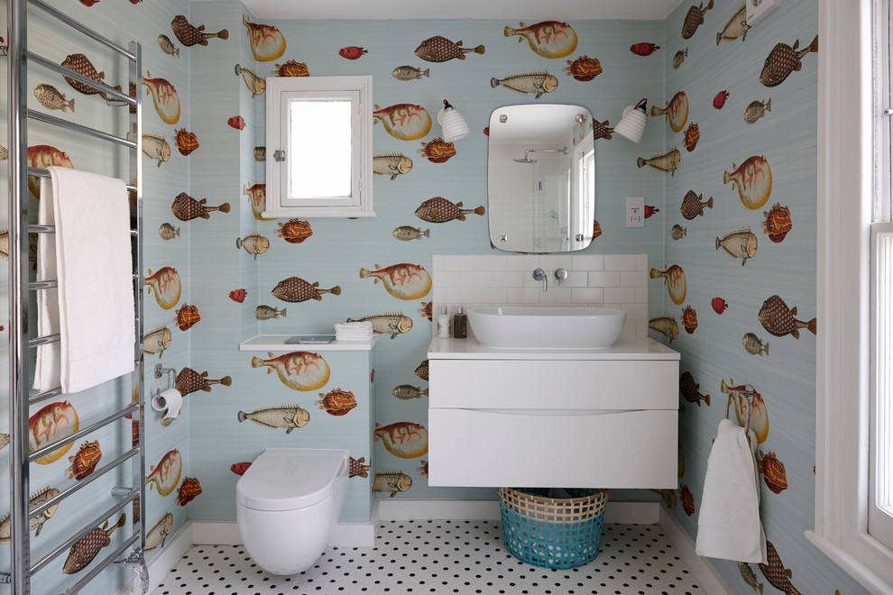 Inspiration for a mid-sized coastal kids' white tile and subway tile ceramic tile bathroom remodel in London with flat-panel cabinets, white cabinets, quartzite countertops, multicolored walls, a vessel sink and a one-piece toilet