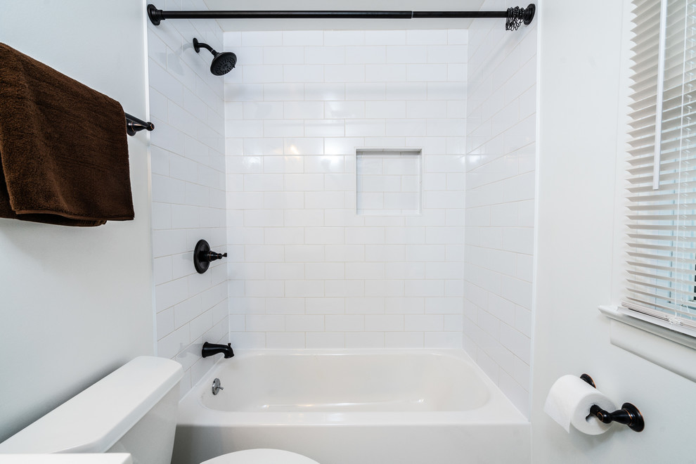 Cette image montre une petite salle de bain design avec des portes de placard marrons et un carrelage blanc.