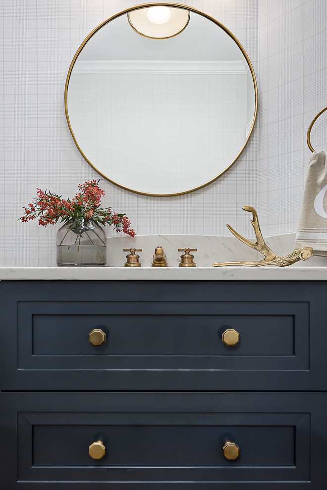 Modelo de cuarto de baño clásico renovado de tamaño medio con armarios estilo shaker, puertas de armario azules, sanitario de dos piezas, suelo de madera en tonos medios, lavabo bajoencimera, encimera de cuarzo compacto y suelo marrón