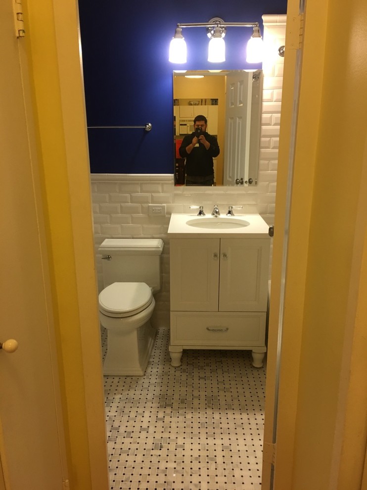 This is an example of a small traditional ensuite bathroom in Chicago with raised-panel cabinets, white cabinets, an alcove bath, a shower/bath combination, a two-piece toilet, white tiles, metro tiles, white walls, marble flooring, a submerged sink, engineered stone worktops, grey floors and a shower curtain.