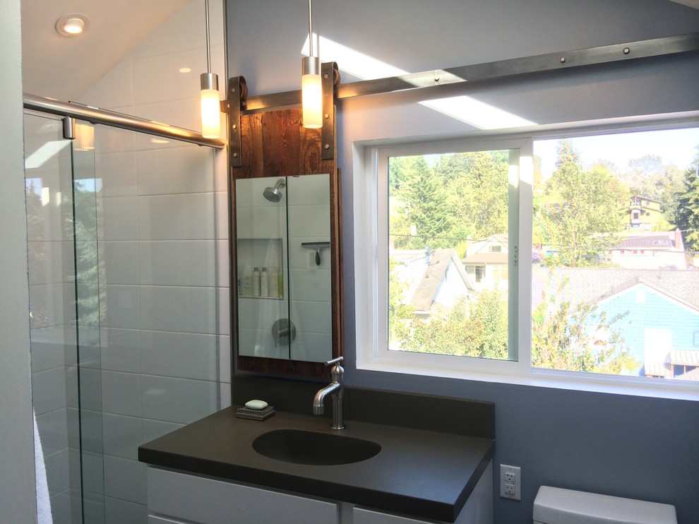 Small modern bathroom in Seattle with an integrated sink, shaker cabinets, white cabinets, concrete worktops, an alcove shower, white tiles, ceramic tiles, blue walls and porcelain flooring.